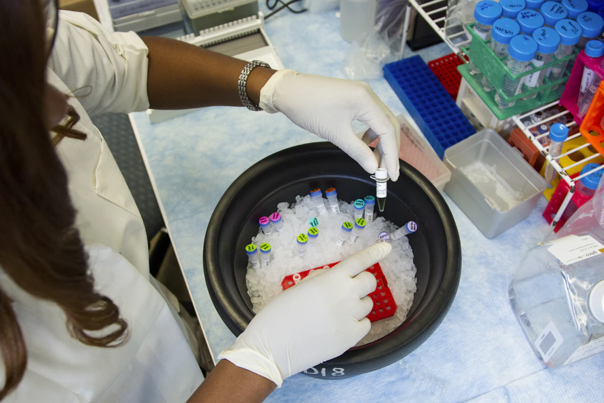 A researcher preparing sample vials
